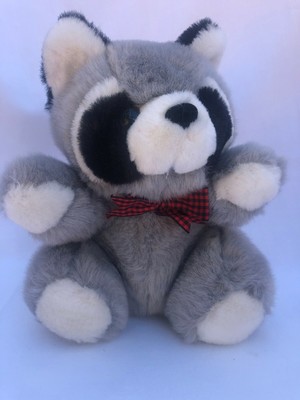 raccoon hugging stuffed raccoon