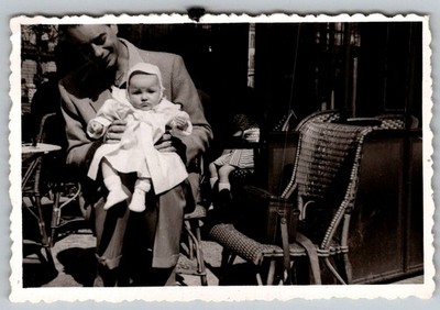 Vtg B&W Snapshot Man Holding Cute Baby In White Outfit At Outdoor Cafe Circa