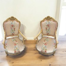 Une paire de fauteuils style Louis XV en bois d'hêtre, rose et beige avec motifs