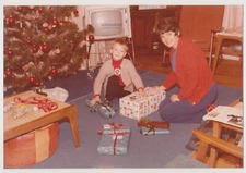 Excited Little Boy Awaiting the Magic Moment of Unwrapping His Christmas Gifts