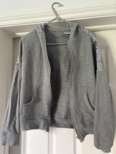 Top grigio marna paillettes con cappuccio e zip. Età 11-12 anni 