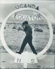 1965 Press Photo Photographer Straddles Equator at Uganda Africa Takes Pictures