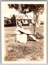 Vtg B&W Snapshot Smiling Young Woman Sitting On Grass By Tree & House Late 1930s