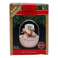 Hallmark Keepsake Ornament Magic Light and Motion! Santa rocks Baby in front of