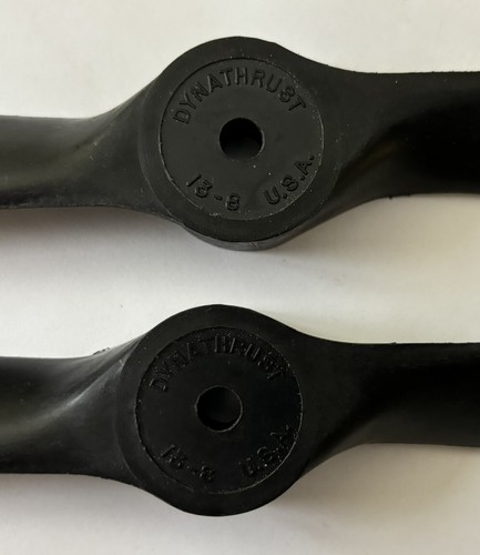 Black DYNATHRUST PROPELLER 13-8 with white circular text reading “DYNATHRUST U.S.A.” on a gray background.