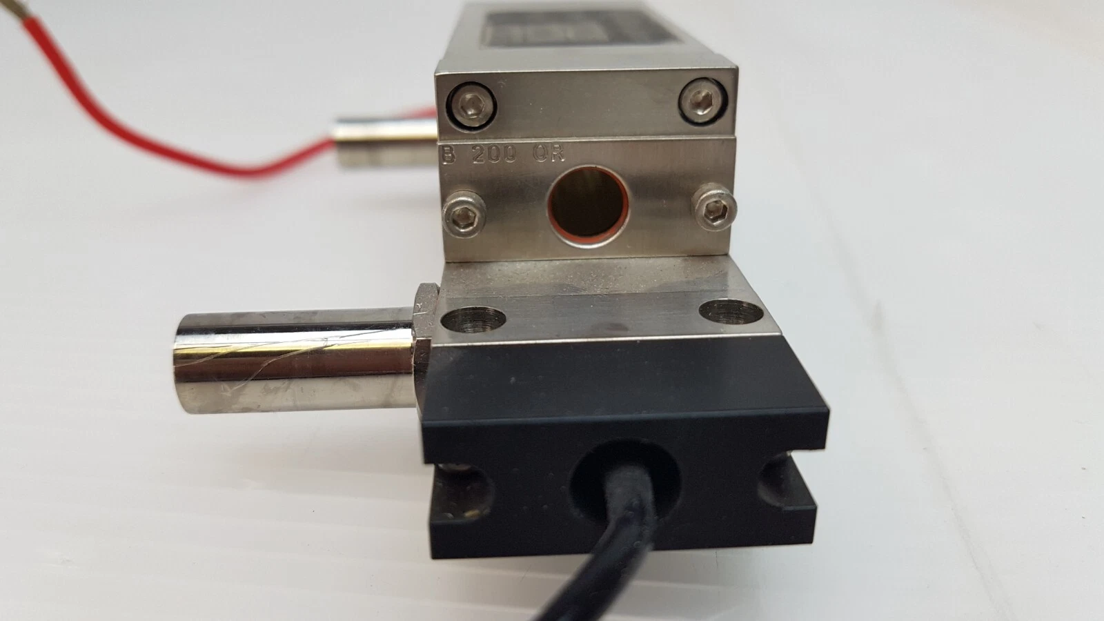 End view of the pump chamber with bore, engraved B 200 CR, and black lead