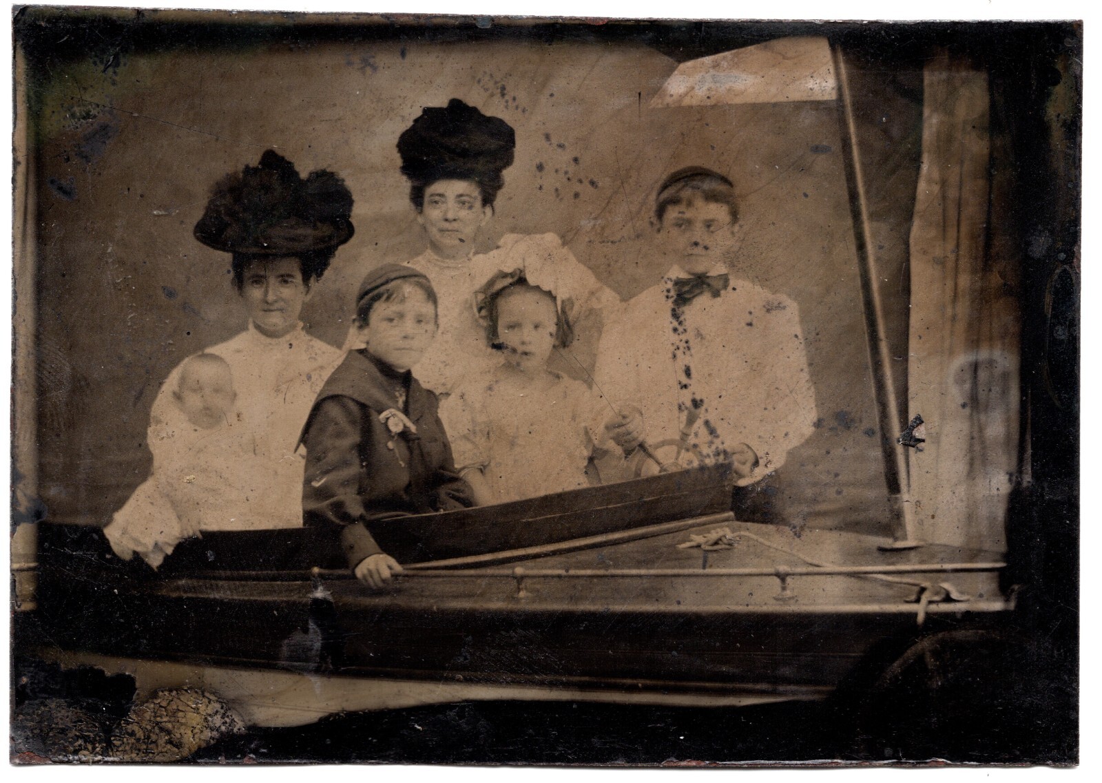 CIRCA 1890s 1/6TH PLATE TINTYPE FAMILY SITTING IN PROP BOAT WITH WHITE FLAG