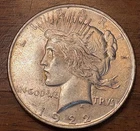 Three 1922-L and one 1923-L Peace Silver Dollars. Circulated.