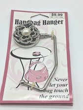 Bardzo ładny nowy na opakowaniu wieszak na torebkę