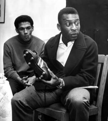 Brazil's football star Pele, right, avoids a challenge from England's