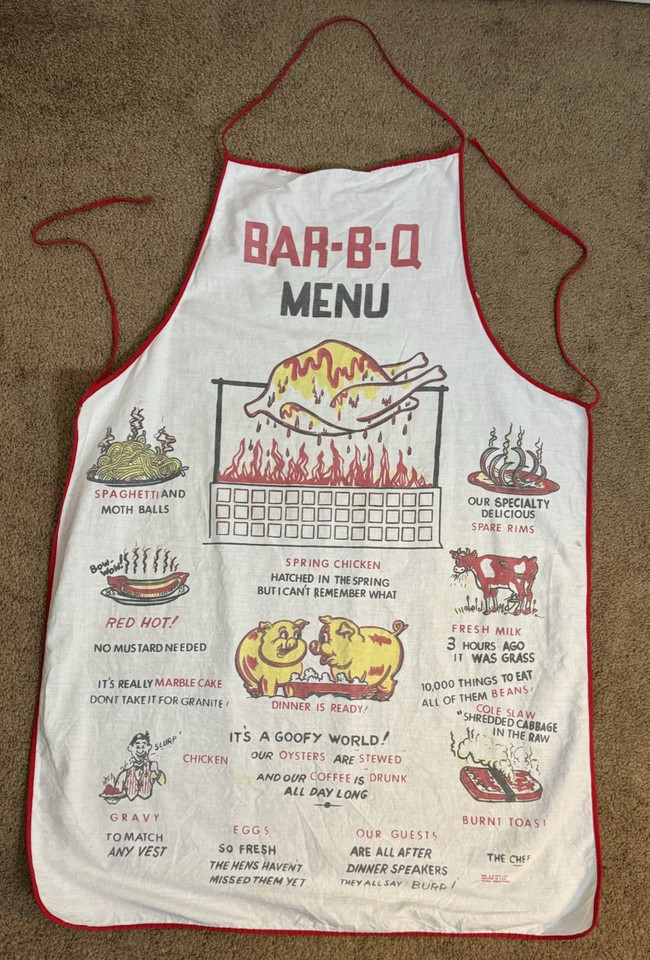 An actual 1950s novelty BBQ apron with hand-drawn cartoon humor — the kind of camp that defined postwar backyard culture and looks amazing framed or worn.