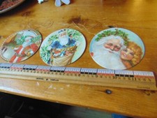 Three 1981 Santa Claus ornaments- cardboard- same scene on both sides