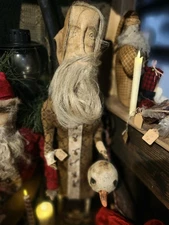 Santa W/ Flax Beard Holding A Snowman Head Christmas Ornament