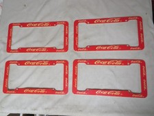 4 COCA COLA VANITY LICENES PLATE SURROUNDS FROM THE COCA COLA COMPANY