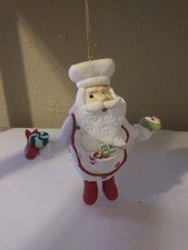 SANTA CLAUSE CLAY DOUGH PAINTED W DANGLING FEET HOLDING TREATS X-MAS ORNAMEENT