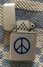Storm Master Silver Lighter, W/Peace Sign Aluminum w/flint & good wick.