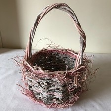Vintage Pink Wicker Basket Made from Intertwined Twigs with Pink Accents