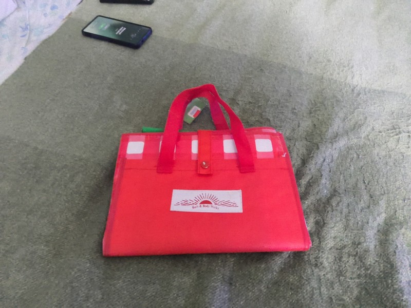 Bath & Body Works branded red picnic mat that folds into a carrying tote.