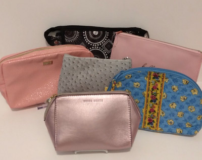 6 Women's cosmetic makeup bags in various colors, styles, and sizes