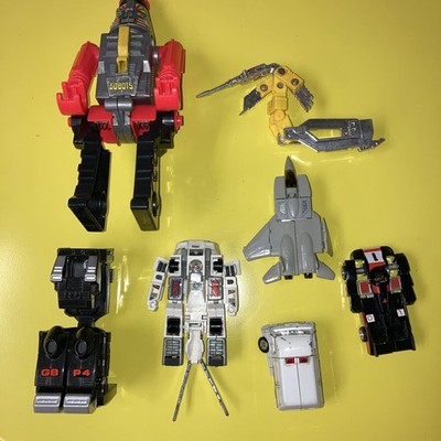 Lot of 7 Vintage Bandi Go Bots Transformer Action Figures.