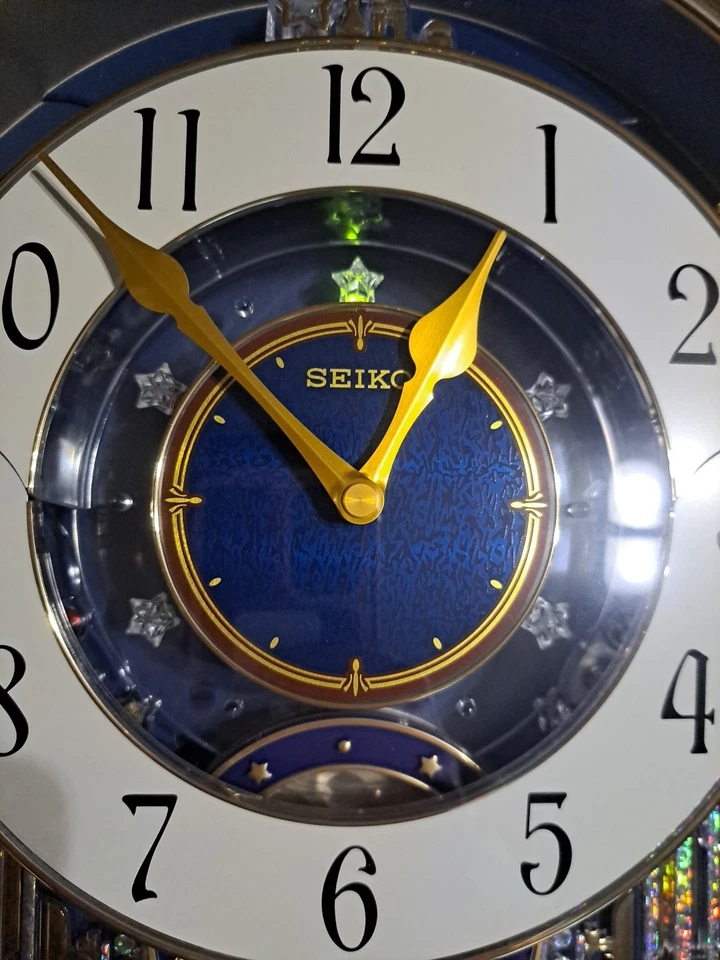 Reloj de pared Seiko Melodías en movimiento ángeles luces de movimiento música Broadway Foto 2 de 4