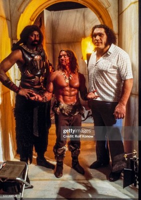 Arnold Schwarzenegger between Andre the Giant and Wilt Chamberlain on the set