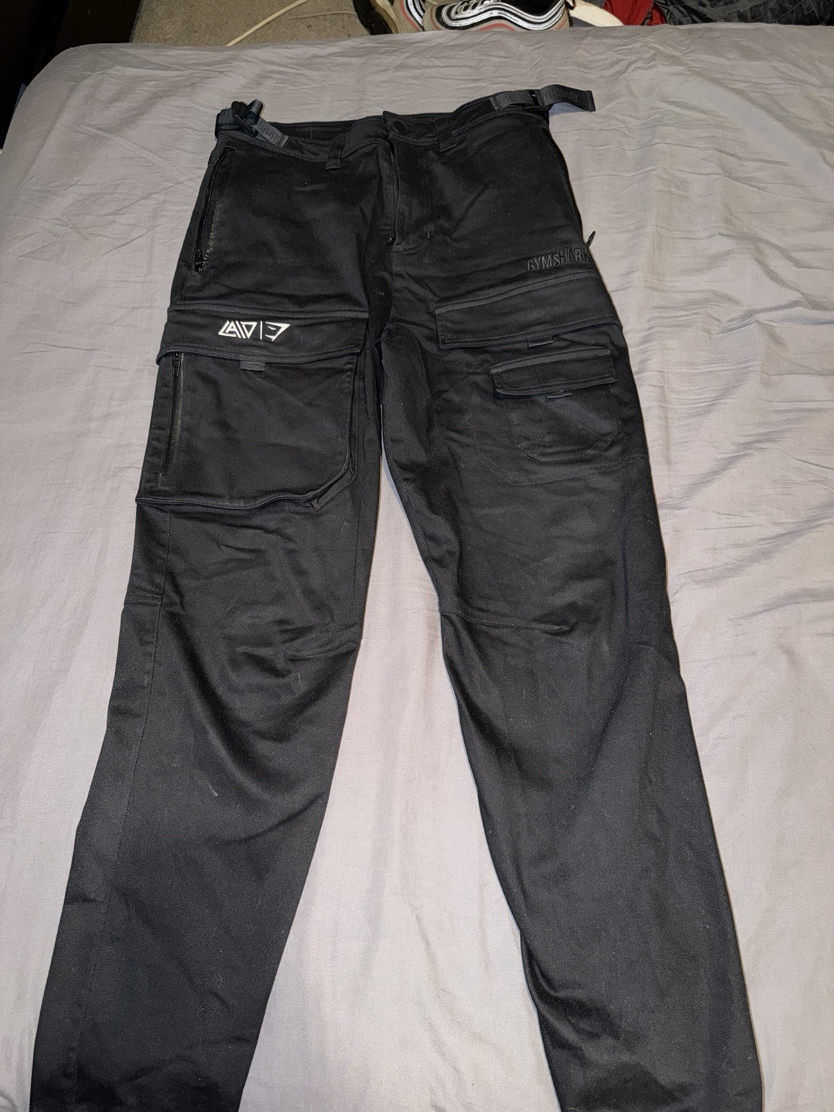 David laid Gymshark Black Cargo Pants Size XS