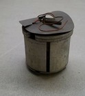 Round silver SW105 Filko ignition parts canister with black lid, exposed metal coil, and visible wiring.