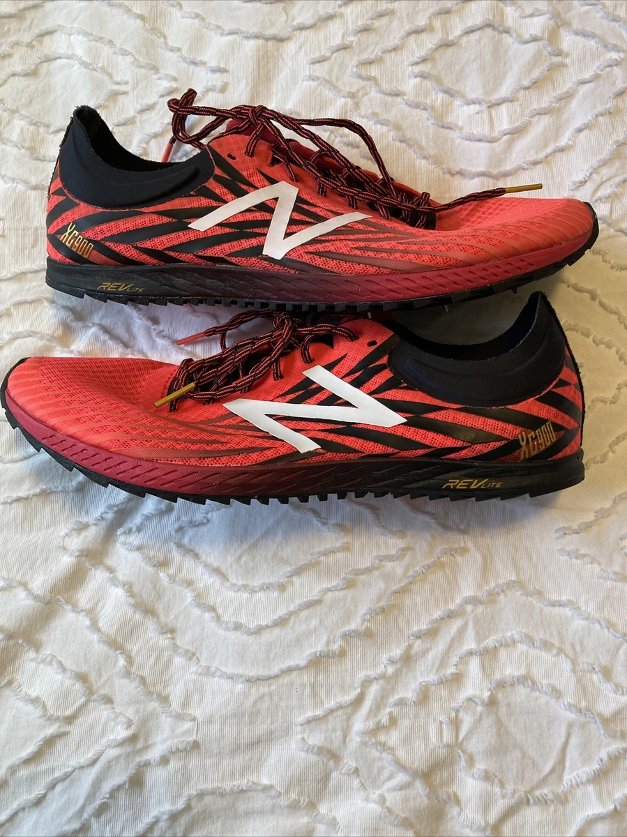 Red new balance best sale spikes