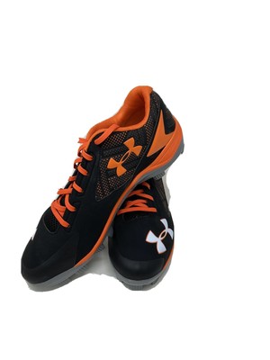 orange and black under armour baseball cleats