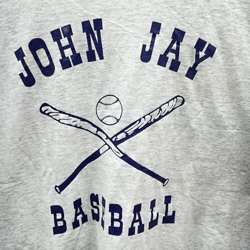 Gray long-sleeve baseball t-shirt with navy “John Jay Best XL” text and crossed baseball bat and softball graphic.
