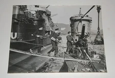A British SUBMARINE crew carrying shells on board. Admiralty photo Aug. 1943