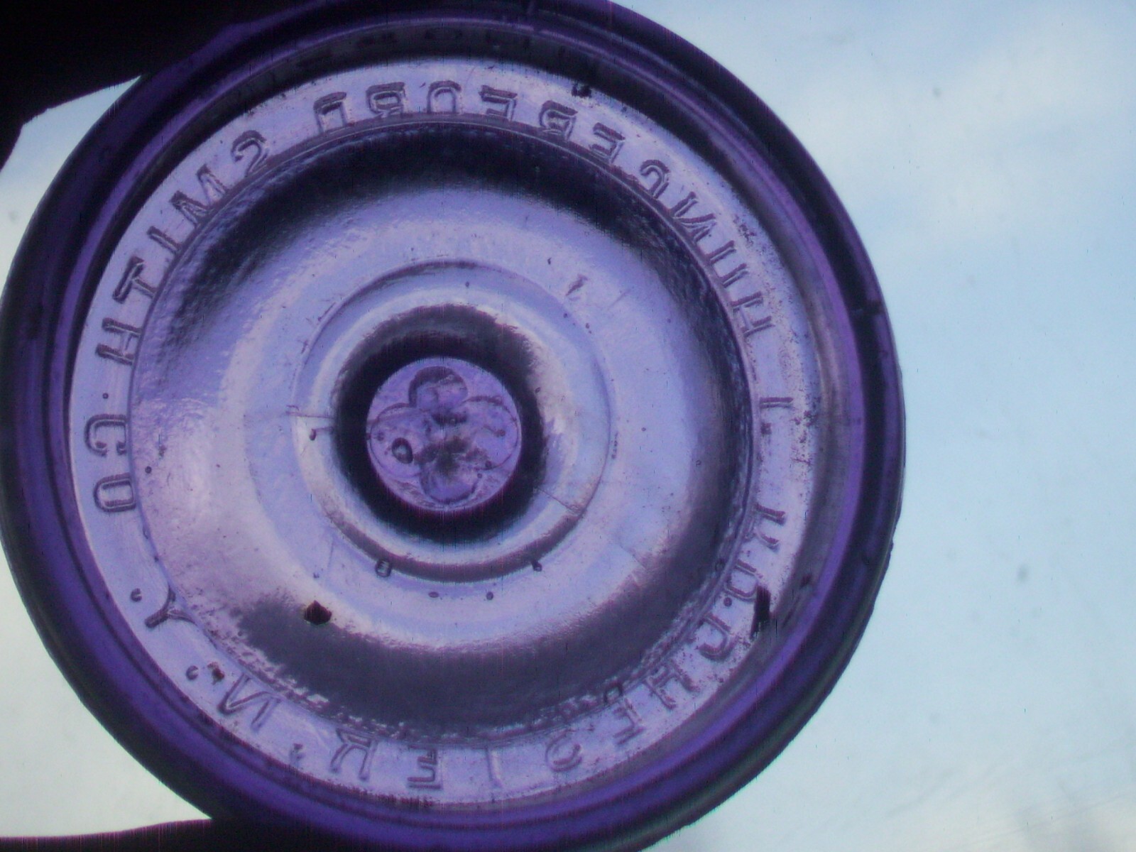 Dark purple J, Hungerford Smith co. Rochester, N. Y. glass top canning jar lid