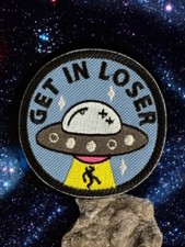 Alien ubduction Patch saying "Get In Loser"