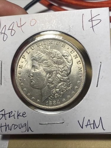 1884 O Morgan Silver Dollar. BU- Strike Through Error