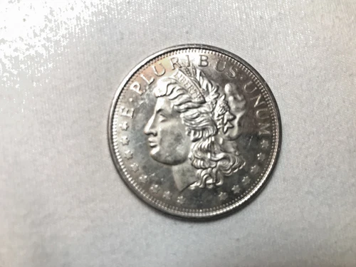 one troy oz. Morgan silver round allmost uncirculated
