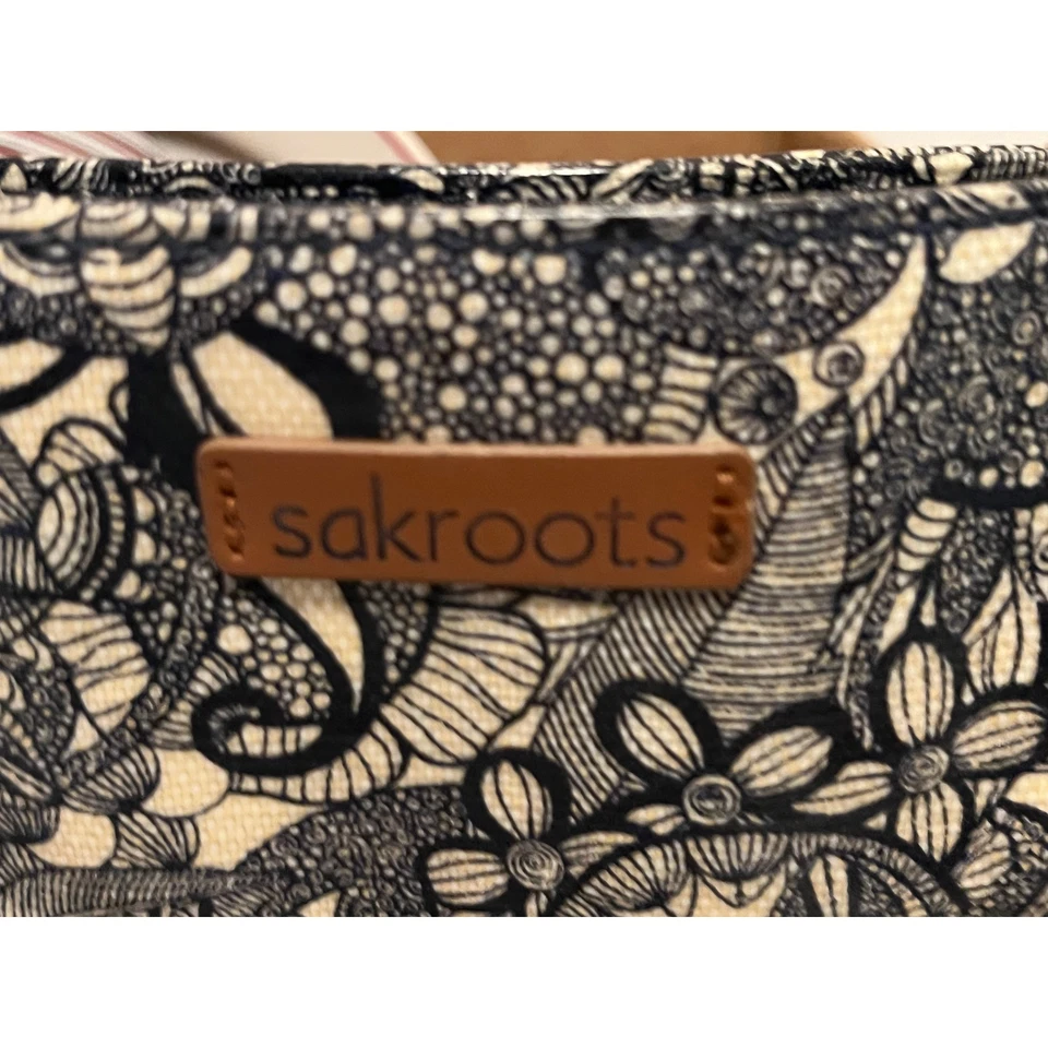 Bolso de Mano Convertible Sakroots Negro Blanco Estampado Floral Acentos de Cuero Foto 2 de 3