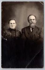 PostCard RPPC Man sporting goatee and Wife sitting still for a photo | c1910s