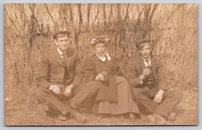 Two Men in Matching Caps & a Woman With Drinks in an Outdoor Scene RPPC Postcard