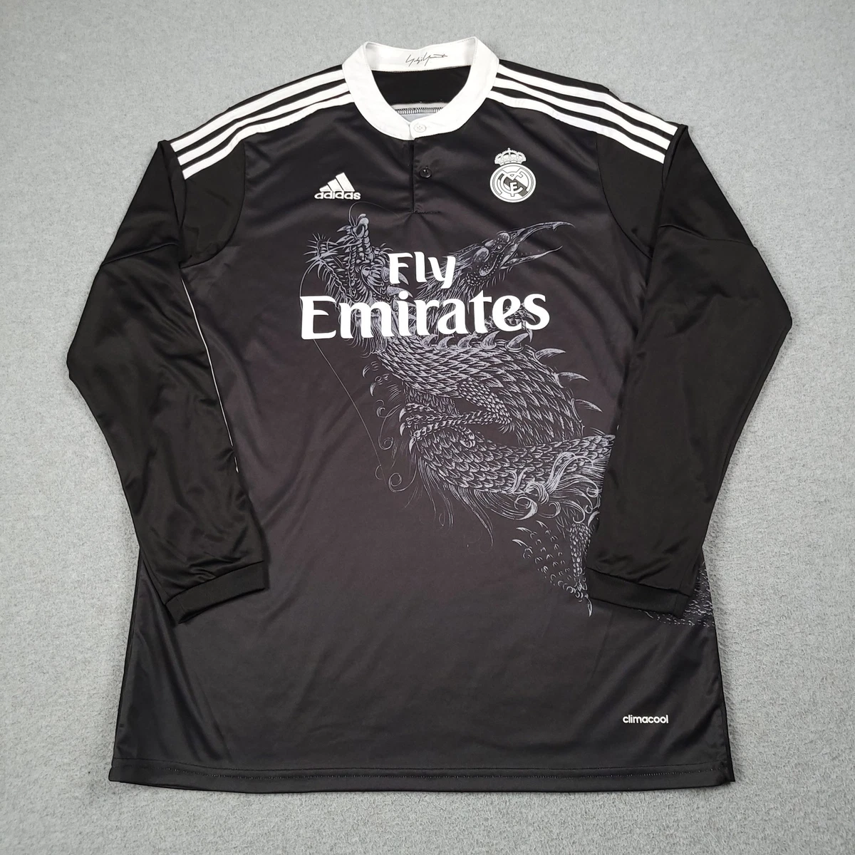Preços baixos em Real Madrid Black International Club Camisas de