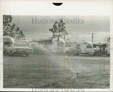 1967 Press Photo Sprinkler at work near car park - lrb17026