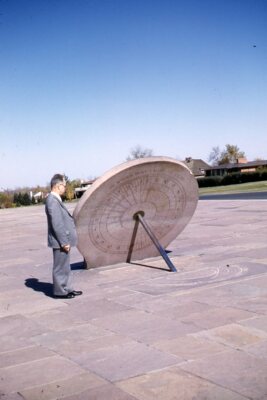 35mm Slide1950s Red Border Kodachrome Man Looking at Sun Dial Calendar