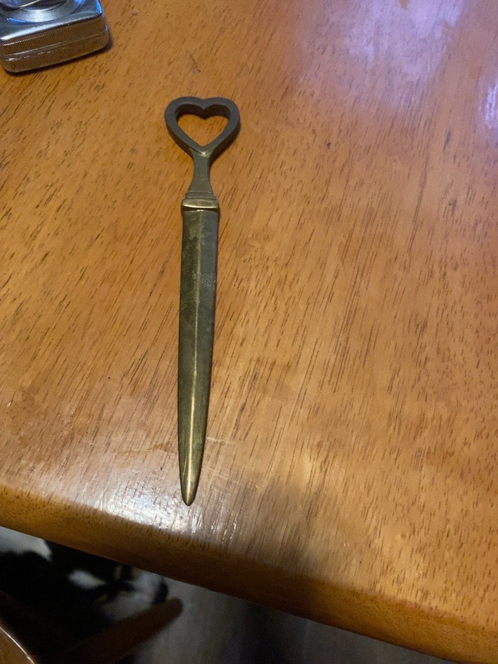 A solid brass heart-shaped letter opener that doubles as a sculptural desk object — genuinely mid-century and actually useful.