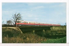 1973 AMTRAK TURBOLINER crosses over Kickapoo Creek, Lincoln IL Trains Postcard