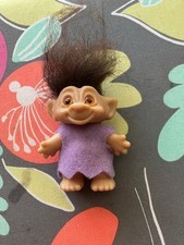 Vintage 1960s Troll Doll with black hair and orange-amber eyes
