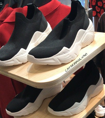 black sock style trainers