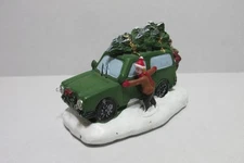 HOLIDAY TIME "TREE DELIVERY" LIGHTS UP STATUE