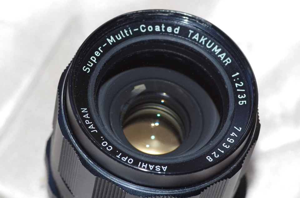 Objectif M42 35mm f2 TAKUMAR, bouchons-étui d'origine + filtre-pare-soleil, TBE - Imagen 2 de 4