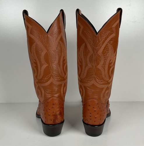 Brown ostrich quill women's cowboy boots with pointed toes and Western flame and swirl patterns on tall shafts.
