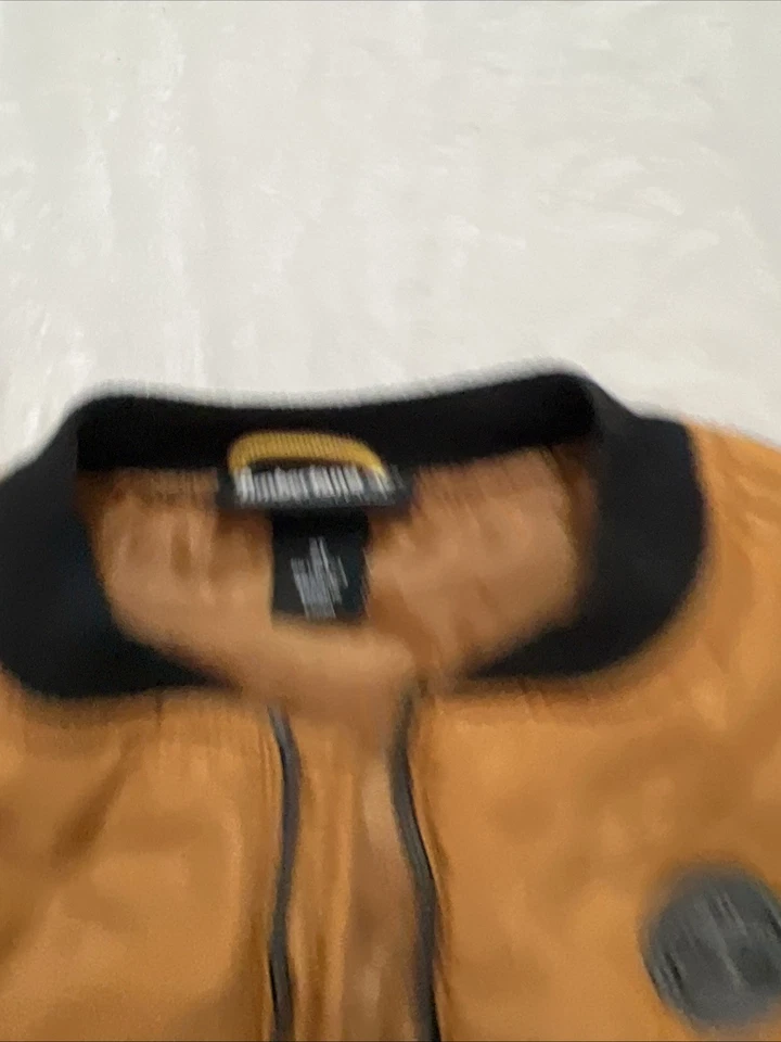 Chaleco acolchado Timberland 2T naranja quemado bolsillos delanteros logotipo Foto 2 de 2